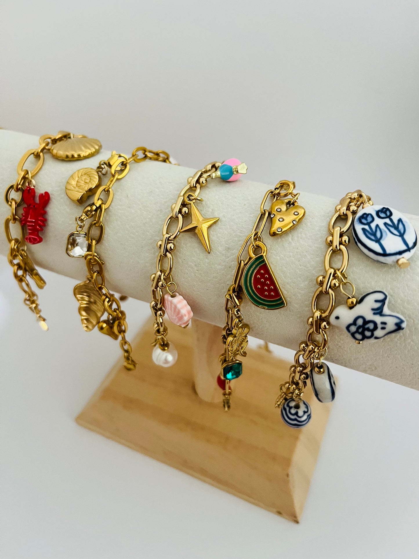 Lobster and shell gold charm bracelet