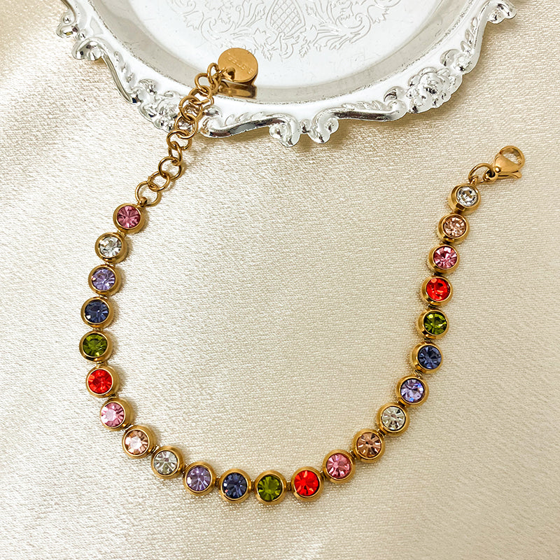Multicolored gemstone bracelet on a decorative stand with a beige background
