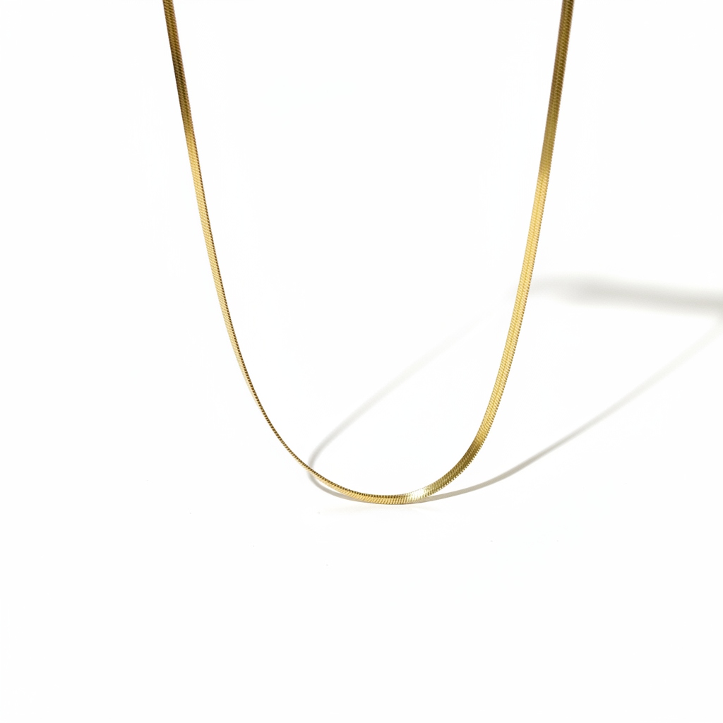 A close up of a gold paper clip necklace that is made from gold plated stainless steel. It is waterproof, tarnish proof and hypoallergenic. The etched design gives the necklace a beautiful shimmer.