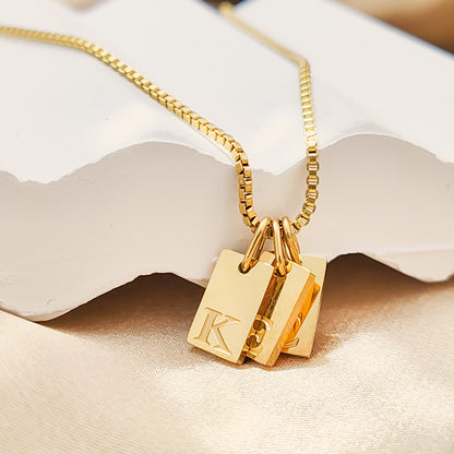 Initial letter gold disk pendant