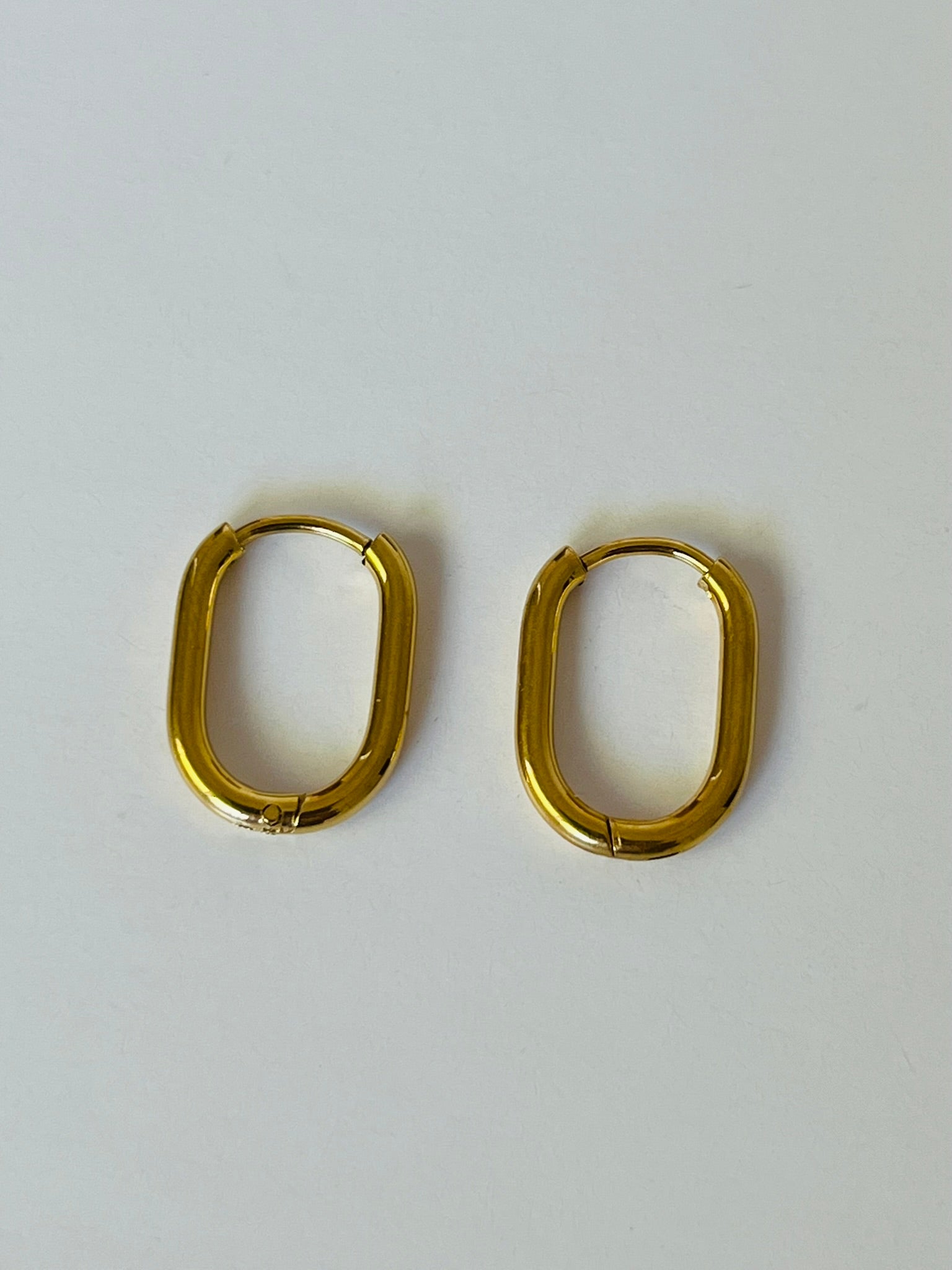Oval gold hoop earrings that are hypoallergenic, waterproof and tarnish proof. 