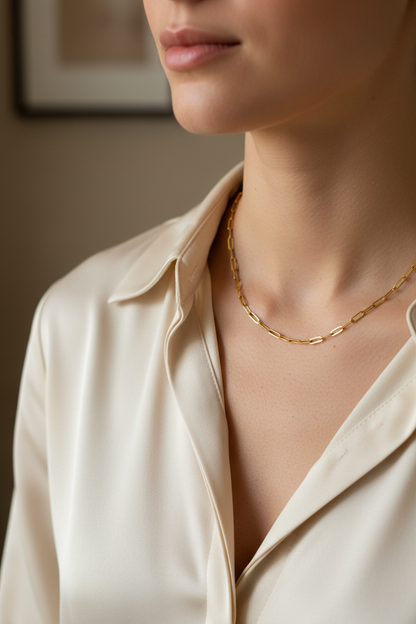 Woman wearing Sofia gold fine paperclip chain necklace, lifestyle editorial shot
